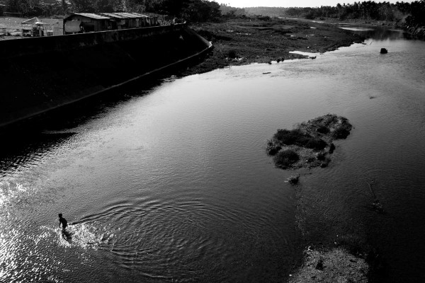 A child plays in the creek near Cosan