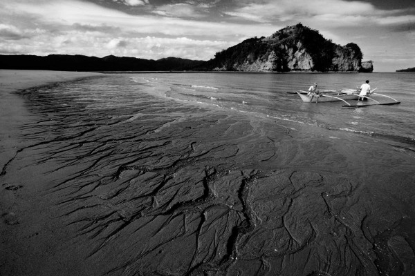 Part of the 7.5 km-long causeway of mine tailings flowing into Calancan Bay.