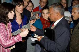 Lauryn Drainie and other Youth Delegates offers a placard to the Environment Minister of Nepal, while blocking the entrance to the negotiations room. Photo Credit: Robert van Waarden