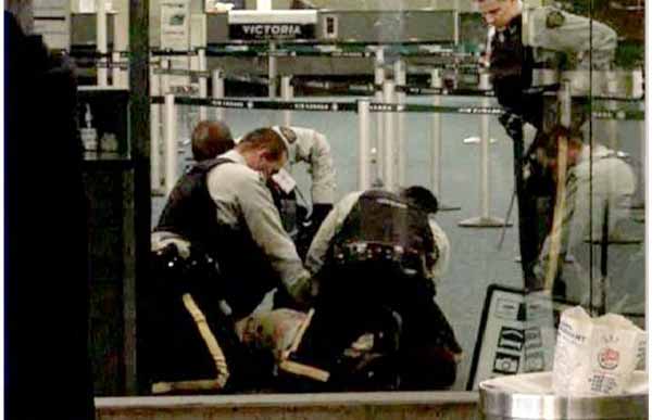 Robert Dziekanski being restrained by RCMP officers in Vancouver International Airport, October 14, 2007, in amateur video of the incident.