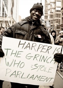 Protestor at a Toronto rally carrying a sign reading: Harper is the Grinch who stole Parliament. Creative Commons photo by Fifth Business.