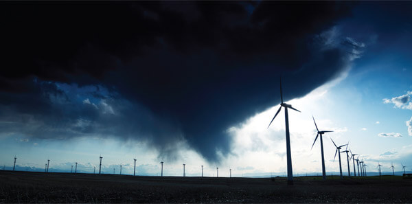 Wind turbines with storm clouds looming.