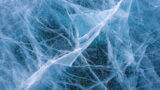 A close-up image of cracked blue ice.